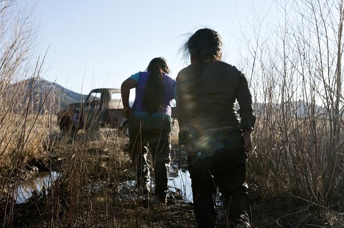 Djamila Grossman | The Salt Lake Tribune

Cousins LaRae and Raenee Bishop-Moon wade through the mud to play in a puddle in spring near their home in Ibapah, Utah, on Thursday, March 31, 2010.