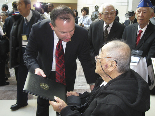 Kevin Carney | Special to The Salt Lake Tribune
Sen. Mike Lee, R-Utah, presents a certificate from his office on Wednesday to Ted Shimizu, congratulating the World War II veteran on his service in the Army's 442nd Regimented Combat Team. Shimizu, of Salt Lake City, was honored among hundreds of Japanese-American veterans with the Congressional Gold Medal, the nation's highest civilian honor.
