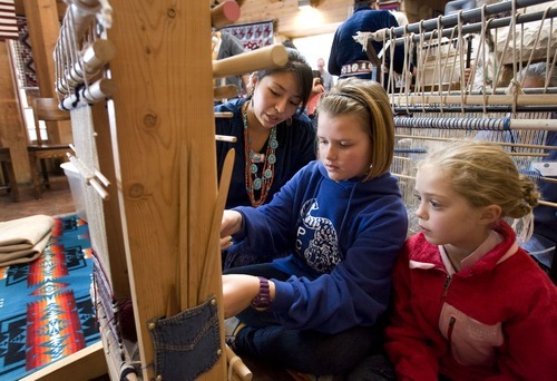 Steve Griffin  |  The Salt Lake Tribune

Rug weaver Bobbijo Whitehair, of Big Mountain, UT, teaches Park City Day School students Orion Martinek, center, and Christine Fischer, how to use a loom during the 21st Annual Navajo Rug Show and Sale in the Snow Park Lodge at Deer Valley  in Park City Friday, November 12, 2010. The event is sponsored by the Adopt-A-Native-Elder ad Navajo weavers. The event runs through Sunday Nov. 14, 2010 and more information is available at www.anelder.org.