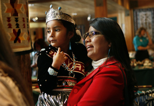 Scott Sommerdorf  |  Salt Lake Tribune
NAVAJO RUG SALE & SHOW
Carley Nez (6 years) is held by her mother Carma Nez of Magna as they listen to native singing at the 20th annual Navajo rug sale/show at Snow Park Lodge in Deer Valley.