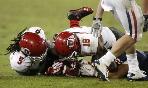 Trent Nelson  |  The Salt Lake Tribune
Utah's Mo Lee, left, and Eric Rowe recover a fumble by Arizona's Keola Antolin during the second half as Utah faces Arizona, college football at Arizona Stadium in Tucson, Arizona, Saturday, November 5, 2011.