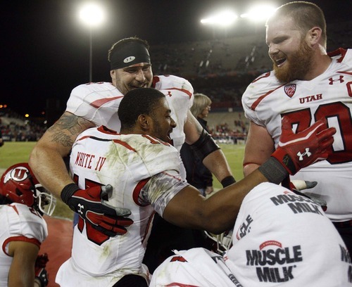 Trent Nelson  |  The Salt Lake Tribune
Utah's John White is congratulated on the bench by teammates Sam Brenner (74) and Tony Bergstrom during the second half as Utah faces Arizona, college football at Arizona Stadium in Tucson, Arizona, Saturday, November 5, 2011.