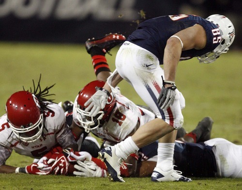 Trent Nelson  |  The Salt Lake Tribune
Utah's Mo Lee, left, and Eric Rowe recover a fumble by Arizona's Keola Antolin during the second half as Utah faces Arizona, college football at Arizona Stadium in Tucson, Arizona, Saturday, November 5, 2011.