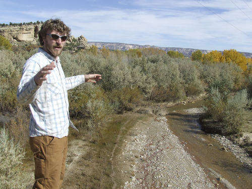 Brandon Loomis | The Salt Lake Tribune
Canyon Country Youth Corps Program Manager Alexander Nees shows a spot on Oct. 24 along Birch Creek, a tributary to the Escalante River, where non-native Russian olive trees have crowded out willows and other native plants -- and with them grazing cattle and wildlife. The youth workers in his conservation corps are among many private and public agencies working to restore the Escalante watershed.