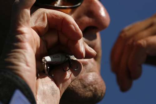 Tribune file photo
An angler ties a lure to fish for cutthroat trout on the Strawberry Reservoir.