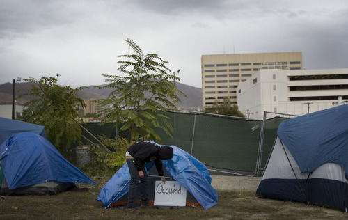 Kim Raff |  The Salt Lake Tribune
Cody Winger an Occupy SLC activists helps set up an additional tent occupation on an abandoned lot at 147 S. State Street in downtown Salt Lake City, UT on Nov. 4, 2011.