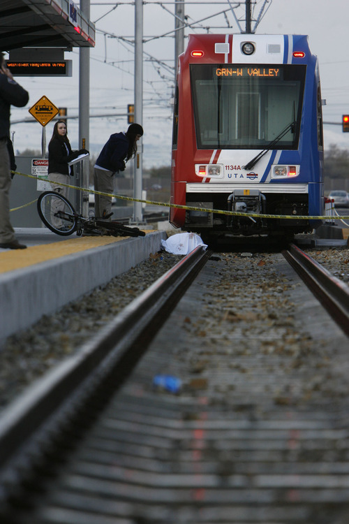 Francisco Kjolseth  |  The Salt Lake Tribune
Crime scene technitians document the scene where a bicyclist was killed after being dragged under by a West bound TRAX train at the Redwood Junction station at 1740 West, Research Way near 2770 South and Redwood on Monday morning, November, 7, 2011,  with the first 911 call being made at 6:47 a.m. The crash involved the Green Line train, running from downtown Salt Lake City to West Valley City.