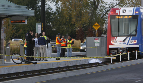 Francisco Kjolseth  |  The Salt Lake Tribune
Investigators document the scene where a bicyclist was killed after being dragged under by a West bound TRAX train at the Redwood Junction station at 1740 West, Research Way near 2770 South and Redwood on Monday morning, November, 7, 2011,  with the first 911 call being made at 6:47 a.m. The crash involved the Green Line train, running from downtown Salt Lake City to West Valley City.