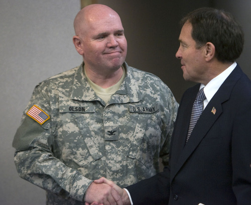 Al Hartmann  |  The Salt Lake Tribune
Colonel Scott Olson of the Utah National Guard, left, shakes hands with  Utah Governor Gary Herbert after he announced an initiative on Wednesday Novmeber 9 to allow Utah military veterans and Utah National Guard members to match their Military Occupational Specialty code which designates specific jobs in the military to civilian occupations.   That will help them count their service work and training toward a specialized license or educational requirement in the job market.