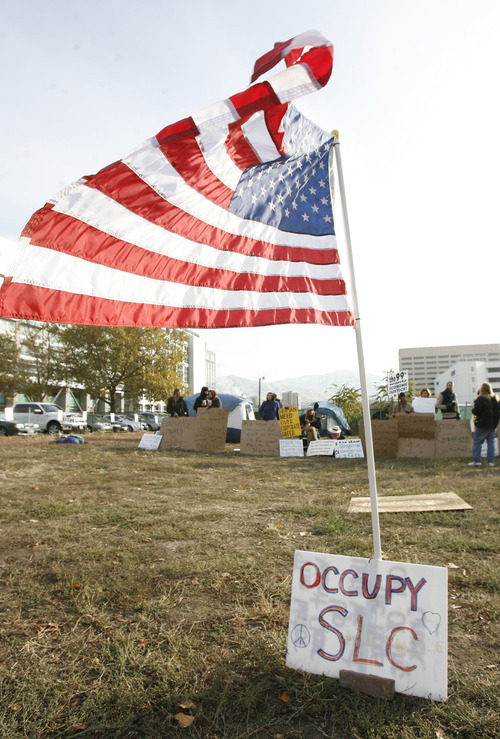 Francisco Kjolseth  |  The Salt Lake Tribune
A small group of Occupy SLC protesters remain camped on a privately owned vacant lot in downtown Salt Lake City on Tuesday, November 8, 2011, across from the Federal Reserve Bank at 147 S State Street. It was expected that they would be removed by police after being warned on Monday but as of Tuesday morning the police were in a 