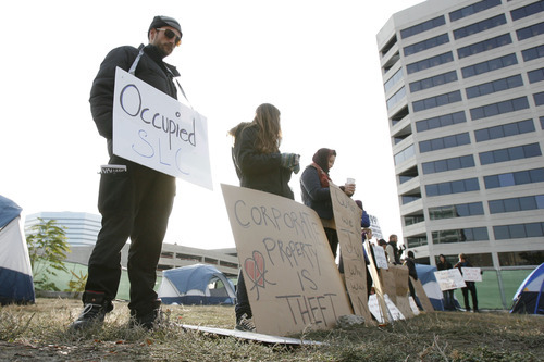 Francisco Kjolseth  |  The Salt Lake Tribune
Seth Neily, left, who normally stays at the Pioneer Park camp joins a small group of Occupy SLC protesters who remained camped on a privately owned vacant lot in downtown Salt Lake City on Tuesday, November 8, 2011, across from the Federal Reserve Bank at 147 S State Street. It was expected that they would be removed by police after being warned on Monday but as of Tuesday morning the police were in a 
