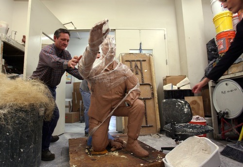 Steve Griffin  |  The Salt Lake Tribune

 Adonis Bronze production manager Denzil Jenks rolls in a piece of the first statue that will be part of the Taylorsville Veterans Memorial. The foundry is casting nine statues sculpted by Brad Taggart.