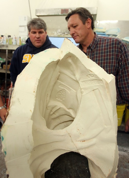 Steve Griffin  |  The Salt Lake Tribune

Sculptor Brad Taggart, left, and Adonis Bronze production manager Denzil Jenks look at a piece of the mold for statues that will be part of the Taylorsville Veterans Memorial. The Alpine foundry is casting the memorial's statues.