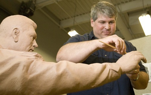Paul Fraughton  |  The Salt Lake Tribune 
Brad Taggart, an art professor at Snow College, sculpts the hand of a statue that will be part of the Taylorsville Veterans Memorial.