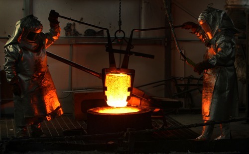 Steve Griffin  |  The Salt Lake Tribune
A vessel containing bronze is raised from a furnace at Adonis Bronze. The metal is being used to cast a statue for the Taylorsville Veterans Memorial.