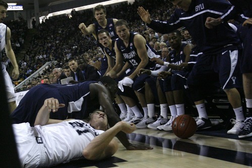 Chris Detrick  |  The Salt Lake Tribune
Utah State Aggies forward Morgan Grim (21) and Brigham Young Cougars guard/forward Charles Abouo (1) go for the ball during the first half of the game at the Dee Glen Smith Spectrum Friday November 11, 2011. Utah State won the game 69-62.