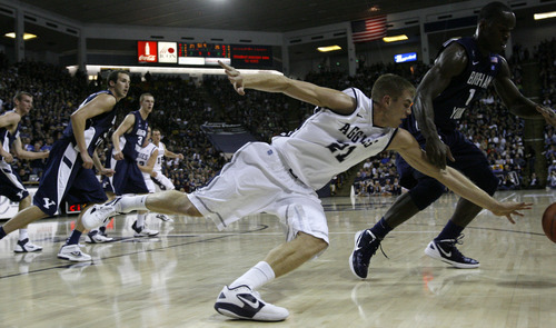 Chris Detrick  |  The Salt Lake Tribune
Utah State Aggies forward Morgan Grim (21) and Brigham Young Cougars guard/forward Charles Abouo (1) go for the ball during the first half of the game at the Dee Glen Smith Spectrum Friday November 11, 2011. Utah State won the game 69-62.