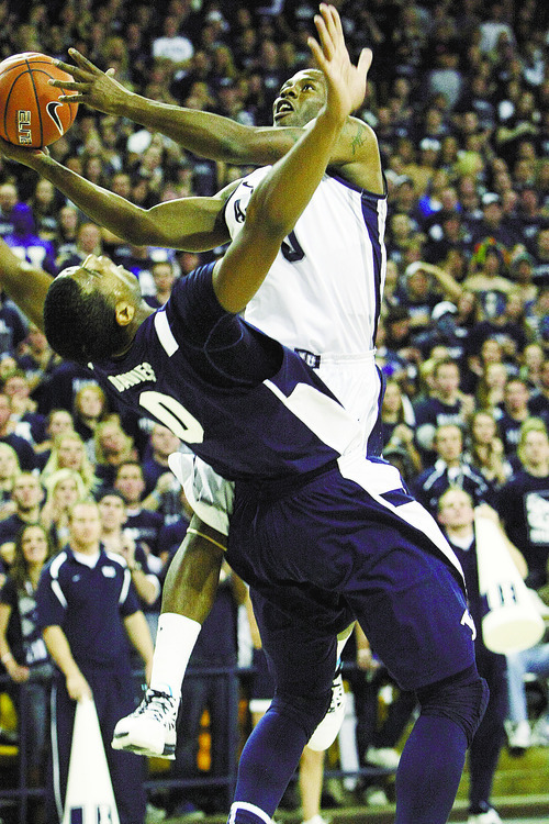 Chris Detrick  |  The Salt Lake Tribune
Utah State Aggies guard Brockeith Pane (0) shoots over Brigham Young Cougars forward Brandon Davies (0) during the first half of the game at the Dee Glen Smith Spectrum Friday November 11, 2011. Utah State won the game 69-62.
