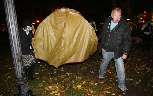 Trent Nelson  |  The Salt Lake Tribune
Activists carry off a tent as Salt Lake City police cleared the Occupy Salt Lake tent city from Pioneer Park in Salt Lake City, Utah, Saturday, November 12, 2011.