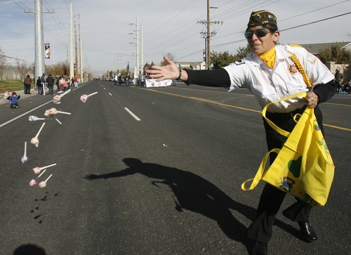 Rick Egan  | The Salt Lake Tribune 
Dora Lawson, of Roy, tosses candy to the crowd as she marches with the Ogden VFW 1481 in the Veterans Day Parade in Taylorsville on Friday.