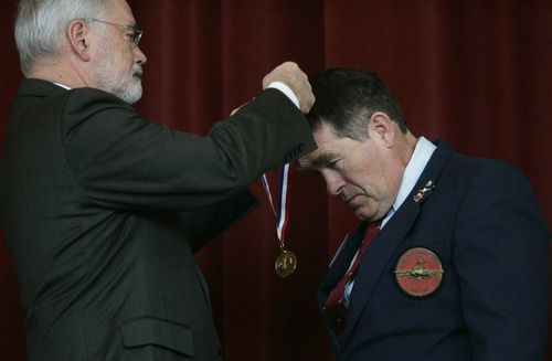 Kim Raff  |  The Salt Lake Tribune
Retired U.S. Marine Rick Warke is awarded a medallion during the Veterans Day celebration at the University of Utah in Salt Lake City on Friday.