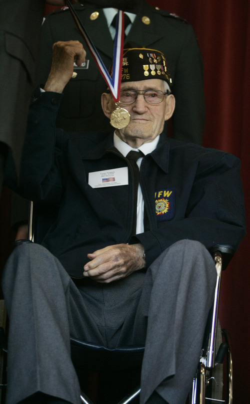 Kim Raff  |  The Salt Lake Tribune U.S. Army veteran Lynn Poulsen shakes a fist in the air while receiving his medallion during the Veterans Day celebration at the University of Utah in Salt Lake City on Friday.