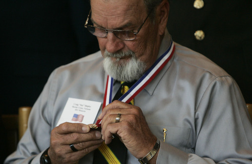 Kim Raff  |  The Salt Lake Tribune
Vietnam veteran Stuart Shipley looks at the medallion he received during the Veterans Day celebration at the University of Utah in Salt Lake City on Friday.