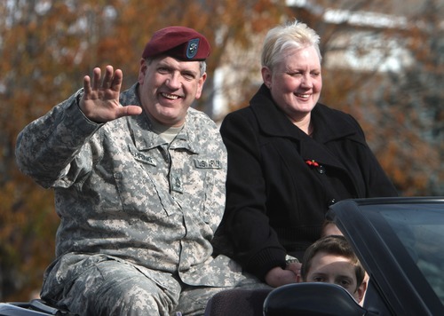 Rick Egan  | The Salt Lake Tribune 
Grand Marshal Dan Nehring and his wife, Heather, ride in the Veterans Day Parade in Taylorsville on Friday.