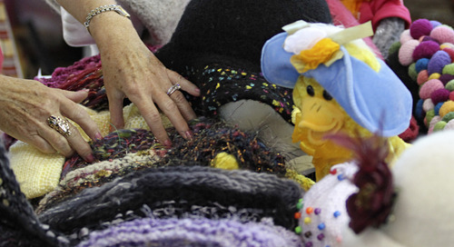 Lennie Mahler  |  The Salt Lake Tribune
Ginny Schulman shows some of the knits and crafts available at the Happy Hats booth during the Jewish Arts Festival on Sunday at the IJ & Jeanné Wagner Jewish Community Center.