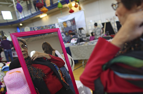 Lennie Mahler  |  The Salt Lake Tribune
Barbara Castillo tries on a scarf at the Happy Hats booth during the Jewish Arts Festival on Sunday at the IJ & Jeanné Wagner Jewish Community Center.