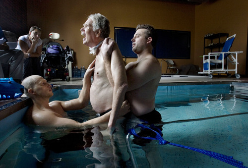 Steve Griffin  |  The Salt Lake Tribune


Brooke Hopkins, who was paralyzed from a bicycle accident three years ago, gasps as he stands tall with the help physical therapist Matt Hansen, left, and LMT/PT Aide Mike Erickson during pool therapy at Neuroworx in South Jordan, Utah Friday, November 11, 2011.
