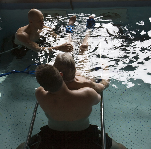 Steve Griffin  |  The Salt Lake Tribune


Brooke Hopkins, who was paralyzed from a bicycle accident three years ago, works with physical therapist Matt Hansen and LMT/PT Aide Mike Erickson during pool therapy at Neuroworx in South Jordan, Utah Friday, November 11, 2011.