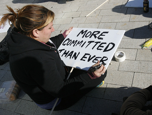 Scott Sommerdorf  |  The Salt Lake Tribune             
Occupy SLC protester Deb Henry finishes making her sign as the protesters gathered and marched to City Hall and the Salt Lake Public Safety Building Sunday.