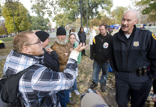 Al Hartmann  |  The Salt Lake Tribune
Salt Lake City Police Chief Chris Burbank, right,  reasons with members of the Occupy Salt Lake in Pioneer Park Friday afternoon November 11.  He announced to occupiers that the camp would have to be dismantled and vacated by sundown on Saturday due to a death in the camp earlier on Friday morning and public safety concerns.
