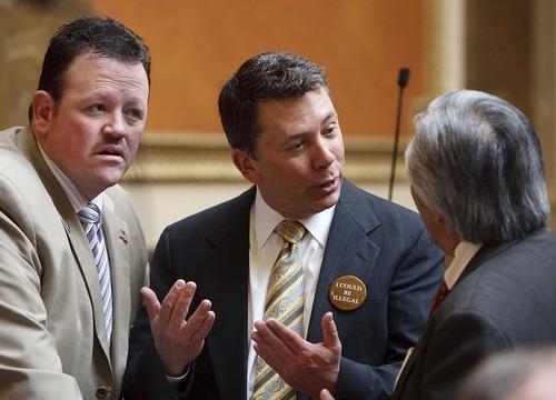 Tribune File Photo
Rep. Carl Wimmer, left, and Rep. Stephen Sandstrom, right, wearing a button reading, 