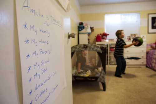 Kim Raff |  The Salt Lake Tribune
David Meikle and Lacy Egbert encourage their children to be thankful for things in their life by listing these things on a chart on their bedroom doors in their home in Salt Lake City.  Sam, left, and Daniel Meikle play in their sister Amelia's room in their home on  Tuesday, Nov. 1, 2011.