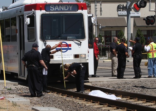 Rick Egan   |  The Salt Lake Tribune
A woman was hit by a TRAX train and killed as she was walking alongside the tracks at the intersection of 7200 South on Wednesday, Aug. 10, 2011.