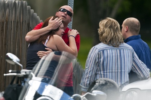 Chris Detrick  |  The Salt Lake Tribune 
A woman and man embrace Wednesday at the scene of the accident where a teenage girl was struck and killed by a TRAX test train running on a West Jordan test line. A witness said two teenage girls were attempting to cross the tracks while the crossing arms were down. The pair avoided an eastbound train, but one of them was struck by a westbound train.