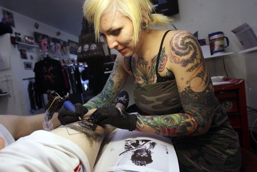 Francisco Kjolseth  |  The Salt Lake Tribune
Tattoo artist Julie Jenson creates the likes of musician Keith Richards on the thigh of Ian James, of Salt Lake City. The Art On You Tattoo shop  opened in historic Magna two years ago.  Owners Storm and Renee Anderson were married eight years ago on Halloween and have a section of their store dedicated to Halloween.