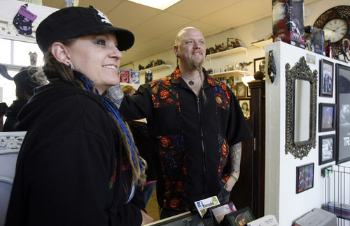 Francisco Kjolseth  |  The Salt Lake Tribune
Art On You Tattoo Shop owners Renee Anderson, left, and Storm are complimented by a happy customer who had gotten a tattoo the day before at their shop in historic Magna on Nov. 10. Renee and Storm who were married eight years ago on Halloween also have a section of their store dedicated to Halloween year-round.