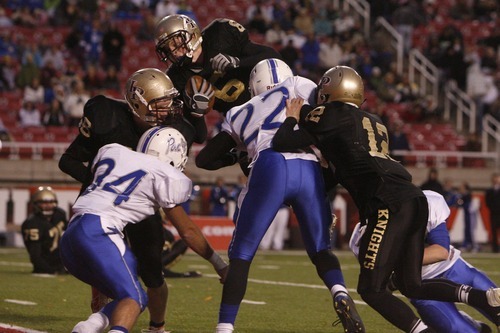Chris Detrick  |  The Salt Lake Tribune
Lone Peak's Talon Shumway (6) dives past Freemont's Justin Pingree (34) and Freemont's Jaz Johnstun (22) for a touchdown during the 5A Championship game at Rice-Eccles Stadium  Friday November 18, 2011.  Lone Peak defeated Fremont 41-21.