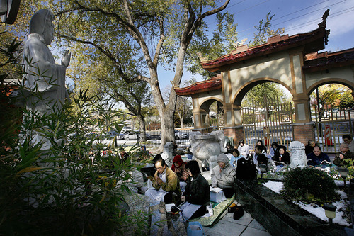 Scott Sommerdorf  |  The Salt Lake Tribune             
Beside a controversial gate, members of the Pho Quang Pagoda Buddhist temple hold their traditional Sunday, 11am, services in the garden outside the temple, Sunday, November 6, 2011. Inside, Nun Kien Khong who has come to hold the deed under questionable circumstances, conducts services. The complex dispute is headed to a January trial.