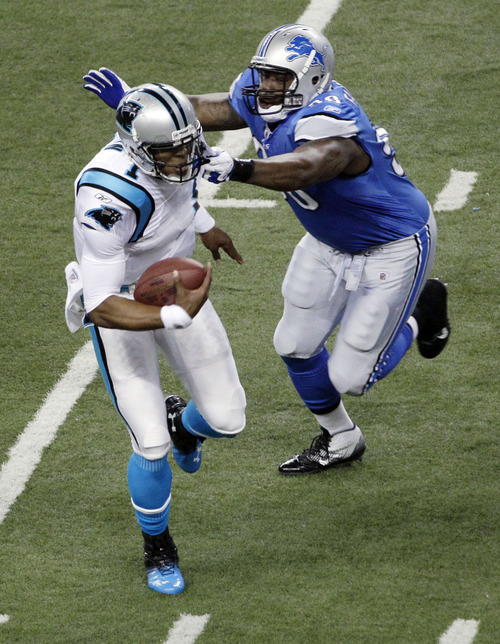 Detroit Lions defensive tackle Nick Fairley (98) pursues Carolina Panthers quarterback Cam Newton (1) during the first quarter of an NFL football game in Detroit, Sunday, Nov. 20, 2011. (AP Photo/Paul Sancya)