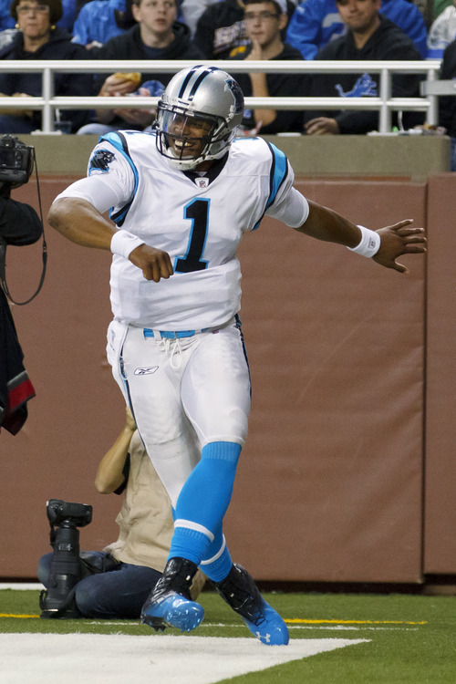 Carolina Panthers quarterback Cam Newton celebrates his 11-yard touchdown run in the second quarter of an NFL football game against the Detroit Lions in Detroit, Sunday, Nov. 20, 2011. (AP Photo/Rick Osentoski)