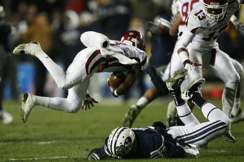 Kim Raff | The Salt Lake Tribune
BYU player Joe  Sampson trips up New Mexico State player Todd Lee  during a game against New Mexico State at Edwards Stadium in Provo, Utah on Saturday, November 19, 2011.