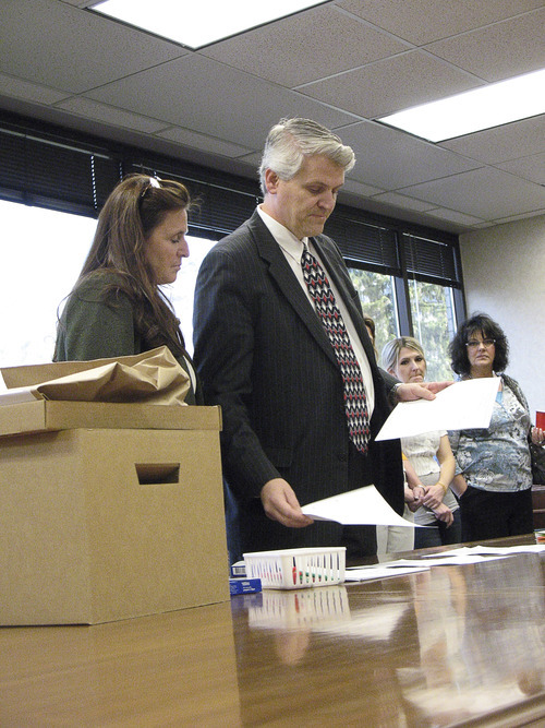 Donald W. Meyers | The Salt Lake Tribune 
Provo City Recorder Janene Weiss and Chief Deputy Utah County Clerk-Auditor Scott Hogensen demonstrate the process for a hand-count that will be used to recount ballots in the Provo Municipal Council District 1 race Wednesday. County election officials opted for a manual recount after optical scanners showed discrepancies in the results between Gary Winterton and Bonnie Morrow.