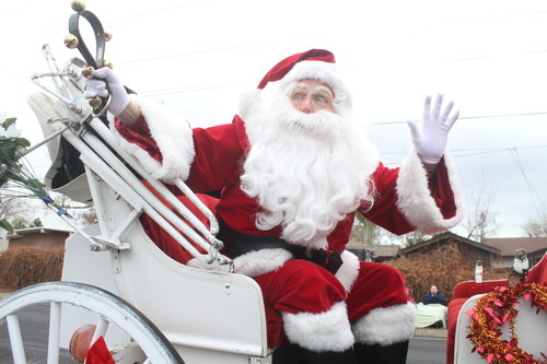 Rick Egan  | The Salt Lake Tribune 

Santa Claus waves to the crowd from his sleigh, in the West Valley Christmas Parade, Friday, November 25, 2011.