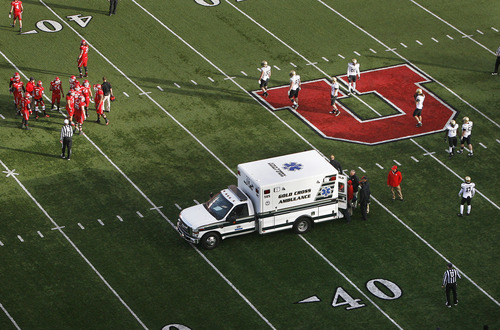 Scott Sommerdorf  |  The Salt Lake Tribune             
Utah players watch as an ambulance carrying team mate OL Sam Brenner leaves the field after the beginning of the second half Friday, Nov. 25, 2011.