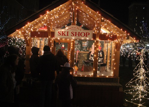 Rick Egan  | The Salt Lake Tribune 
People peek in the windows of the ski shop in the Christmas Village in the Municipal Gardens in Ogden on Saturday. The village has been a holiday tradition in Ogden for 49 years.