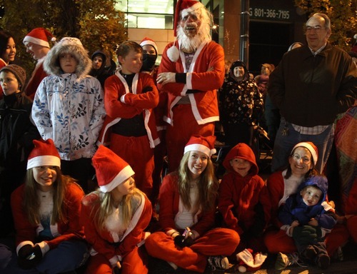 Rick Egan  | The Salt Lake Tribune 
Paradegoers dressed like Santa, from the Santa Run, watch the annual Holiday Electric Light Parade on Washington Boulevard in Ogden on Saturday.